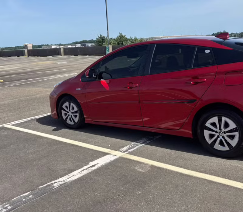 driver side view of Toyota Prius 2017 car rental parked and ready in Baton Rouge