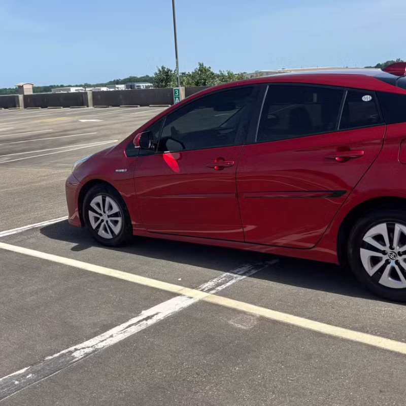 driver side view of Toyota Prius 2017 car rental parked and ready in Baton Rouge